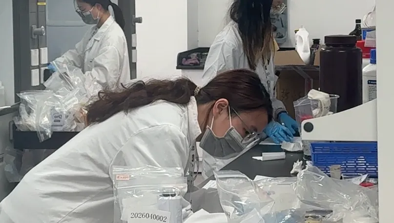 Laboratory analyst performing cosmetic formulation reverse engineering on skincare samples