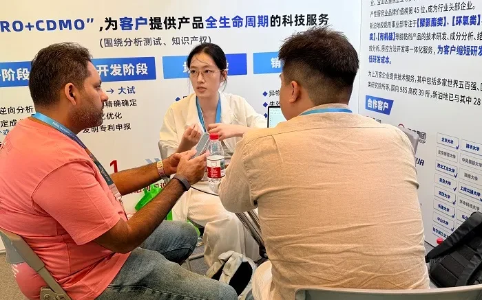 Xinbodi technical specialist discussing adhesive analysis projects with visitors at ASE CHINA 2026